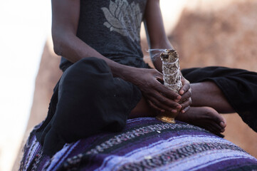 Photographs of a young black gay man practicing Reiki in the desert.  - 619525111
