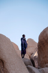 Photographs of a young black gay man practicing Reiki in the desert.  - 619525707