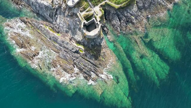 4k aerial footage looking down at the rocky coast of Pendennis Point near Falmouth, Cornwall, UK