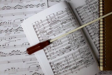 Conductor baton on music score close-up