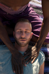 Photographs of a young black gay man practicing Reiki in the desert. 