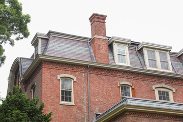 towering brick building represents the solid foundation and resilience of the business world, signifying commercial success and financial stability