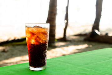 Cool freshly Cola soad whiskey and ice on table background, Summer drinks with ice