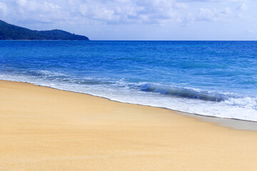 Light blue sea waves and island on clean sandy beach, Tropical white sand beach and soft sunshine background