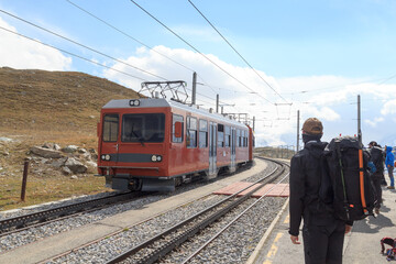 Gornergrat Railway railcar and mountaineers at Rotenboden railway station near Zermatt, Switzerland