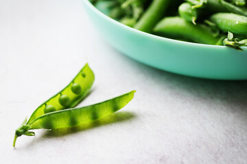 Green pea pod near plate. Healthy eating. Vegan food