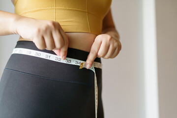 woman want to lose weight with a centimeter Shape up healthy stomach muscle and diet measuring...