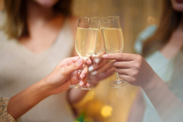 Group of friends celebrating with champagne  Close up on hands.
