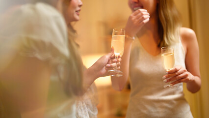 Group of friends celebrating with champagne  Close up on hands.
