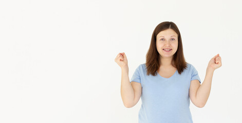 Fototapeta na wymiar Enthusiastic woman rejoicing, say yes, looking happy and celebrating victory, champion dance, fist pump gesture, standing over white background