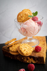 Raspberry ice cream in a bowl. on a dark background. Sweet dessert