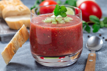 Cold soup Gazpacho served in glass garnished with cucumber and cilantro, horizontal