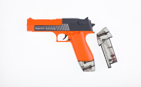 orange toy water gun isolated on white background