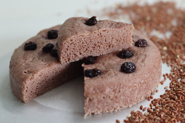 Slices of Navara rice vattayappam. Steamed rice cake made with a fermented batter of navara rice and coconut and steamed in a round dish.