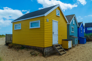 Fototapeta na wymiar Hengistbury Head, UK - July 1st 2023: Beach huts on Mudeford Sandbank.