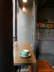Empty coffee cup on wooden table in cafe window