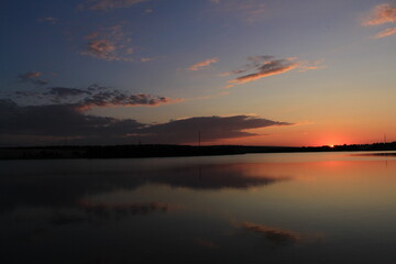 Fototapeta na wymiar A sunset over a body of water