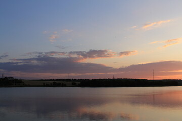 A body of water with a sunset in the background