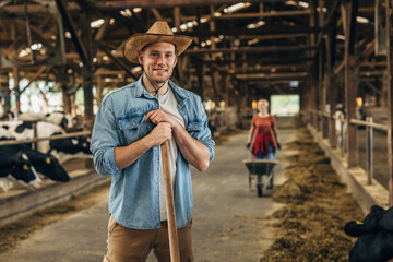 Handsome farmer working in a stable.