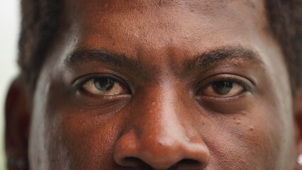 Fototapeta premium Close-up of the eye of a confident black man