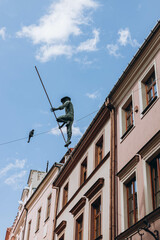 Lublin, Poland- May 10, 2023:  Sculpture of Rope Walkers at highline at Market Square. Equilibrist or balance master in old town. The view of the statue in the city center on the old street