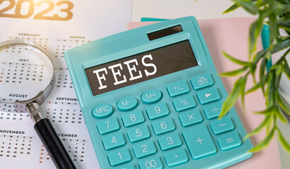 Fees text displayed on calculator and magnifier. bank fees, service fee concept.