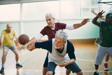 Seniors playing basketball in an indoor gym