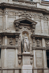 Milan, Italy- May 13, 2023:   Gothic architecture and white marble statues. Top tourist attraction on piazza in Milan, Lombardia, Italy. Medieval Elements of architecture, ancient arches, columns