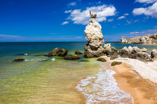 Rocks and stones of unusual bizarre shape on the sandy sea shore