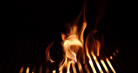 The fire burns through the grill grate. Hellish barbecue. Hearth in the fireplace.