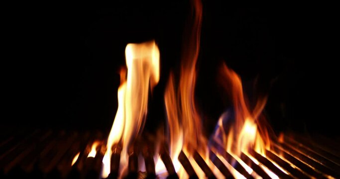 The fire burns through the grill grate. Hellish barbecue. Hearth in the fireplace.