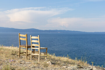 two empty chairs overlooking the ocean