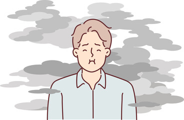 Man stands in smoke and tries to hold breath to avoid getting harmful substances into lungs