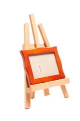 Artist wooden easel with a wooden blank frame isolated on white