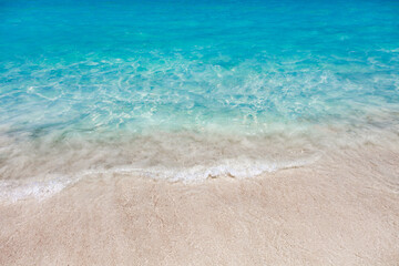 Fototapeta na wymiar Sea surf with turquoise water close-up on sandy tropical beach