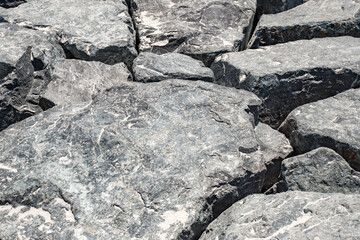 Stones large boulders breakwaters close-up, background