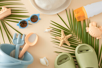 Seashore getaway idea for kids. Top view of beach toys, eyeglasses, sunscreen bottle, sun hat, palm leaves, flip-flops, starfish, seashells on pastel beige background with space for advert or text