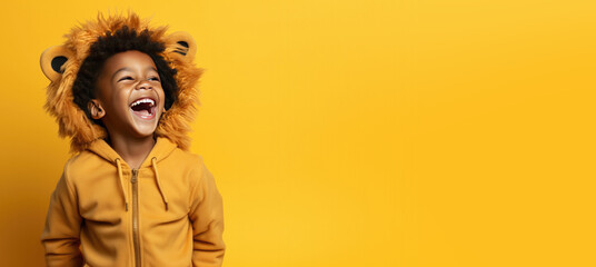 Cute Young Boy Dressed as a Lion  for Halloween on an Yellow Banner with Space for Copy