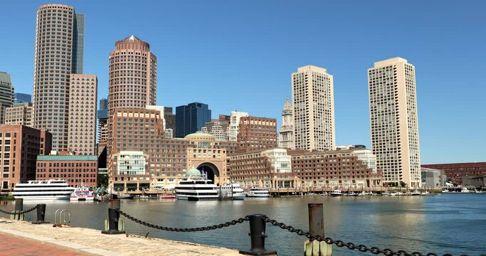 Downtown city skyline view of the office buildings and apartments from the harbour wharf in Fan Pier Park by the North End of downtown Boston Massachusetts United States
