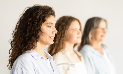 Fototapeta premium Positive caucasian mature, old and teen woman and girl, profile, isolated on white background, studio