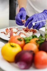Fresh prosciutto, mozzarella, tomatoes and vegetable on the table.
Prosciutto Wrapped Mozzarella Sticks.