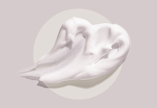 Cosmetic foam texture cleanser or shaving cream on gray circle background