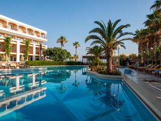 Fototapeta na wymiar Rethymnon, Crete, Greece - Juni 15, 2022: Swimming pool at hotel in Rethymnon on Crete, Greece