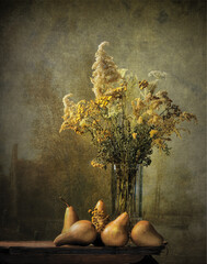 Still life of dried flowers and pear fruits.