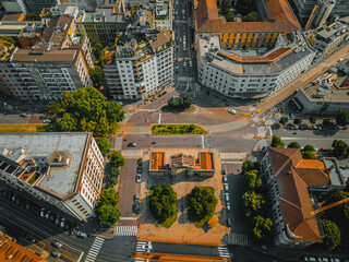 Streets from the top of the European megapolis, Milan, Italy. Top view of house roofs and roads with cars. 