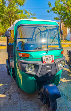 Green turquoise tuk tuk white TukTuks rickshaw in Mexico.