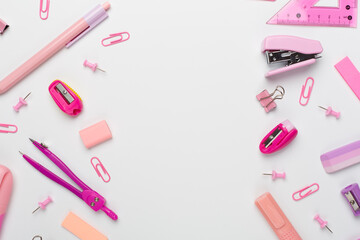 Pink school stationery on color backgroung, top view