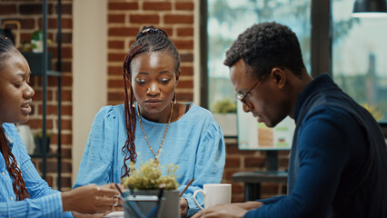 Executive workers looking at data report on documents, reviewing paperwork and thinking about new business solutions in office. Team of partners collaborating on profit development.