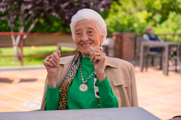 An elderly woman dancing in the garden of a nursing home or retirement home