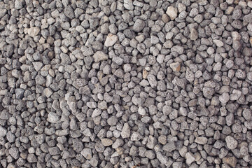 Gray stones texture. Natural background. Small road stone background, gravel pebbles stone texture, granite,marble. Pebbles in the ground. Texture of little rocks.